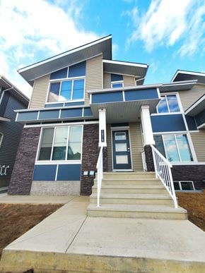 Edmonton apartment for rent - A modern house with a front porch and stairs leading to the entrance.