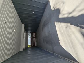 Kelowna apartment for rent - A long, narrow corridor with a shadow cast on the wall.