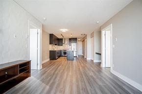 Burnaby apartment for rent - an empty living room and kitchen with wood floors