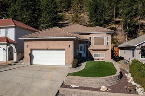 Kelowna apartment for rent - A house with a brown roof and a white garage door.