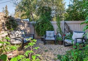 Edmonton apartment for rent - A backyard with a brick patio and two chairs.