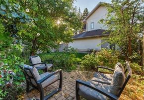 Edmonton apartment for rent - Two chairs are placed on a patio in front of a house.
