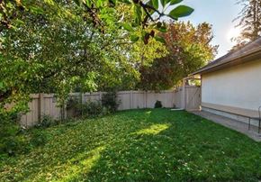 Edmonton apartment for rent - A backyard with a fence and a shed.