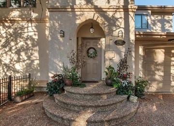 Edmonton apartment for rent - A house entrance with a wreath on the door and plants on the steps.