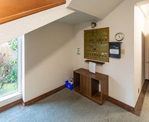 Vancouver apartment for rent - A room with a wooden bench and a control panel on the wall.