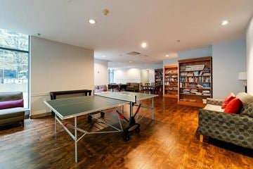 Vancouver condo for rent - A ping pong table is in the middle of a living room.