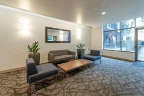 Vancouver condo for rent - A conference room with a table, chairs and a mirror on the wall.