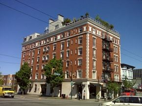 Vancouver apartment for rent - a building on the corner of a street with a tree on top of it