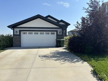 Fort Saskatchewan apartment for rent - A two-car garage with a white door and a brown roof.