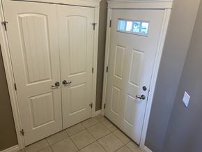 Leduc triplex for rent - A white door with a window above it.