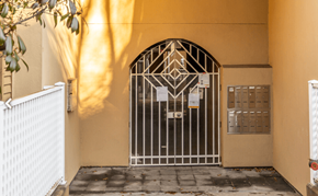 Vancouver apartment for rent - a gate in front of a building with a yellow wall