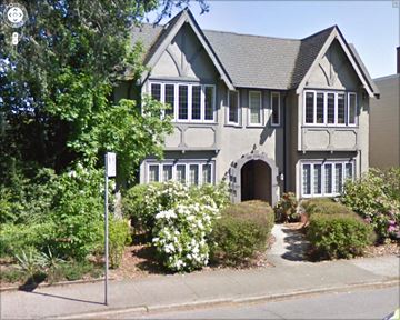 Vancouver apartment for rent - A grey house with white windows and a grey roof.