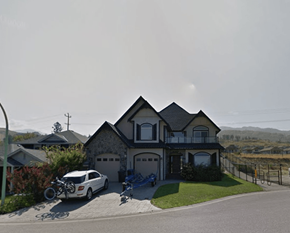Kelowna apartment for rent - A house with a white car parked in front.