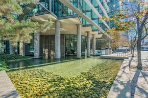 Vancouver condo for rent - A modern building with a water feature in front.
