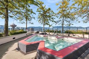 Vancouver condo for rent - A hot tub on a patio with a view of a city skyline.