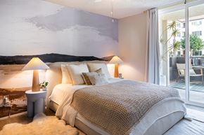 San Diego apartment for rent - A bedroom with a large bed and a painting on the wall.