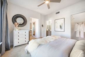 Centennial apartment for rent - A bedroom with a large bed and a dresser.