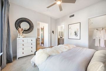 Centennial apartment for rent - A bedroom with a large bed and a dresser.