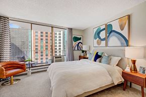 Seattle apartment for rent - a bedroom with a large bed and a large window
