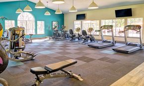 Beaverton apartment for rent - a gym with cardio equipment and windows