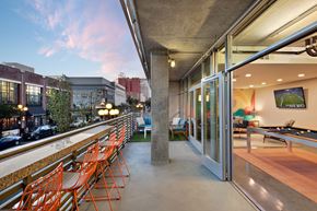 San Diego apartment for rent - A patio with orange chairs and a pool table.