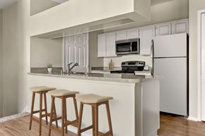 Richardson apartment for rent - A kitchen with white cabinets and a white refrigerator.