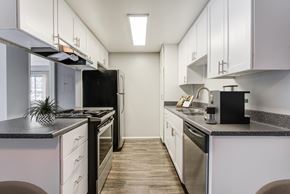 Chula Vista apartment for rent - a kitchen with white cabinets and stainless steel appliances