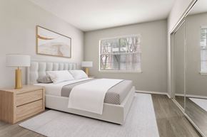 Richardson apartment for rent - A bedroom with a large bed, a nightstand with a lamp, and a framed picture on the wall.