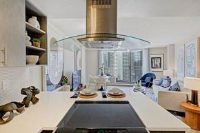 Seattle apartment for rent - a kitchen with a stove and a view of a living room