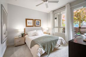 Woodland Hills apartment for rent - A bedroom with a bed, nightstand, and a ceiling fan.