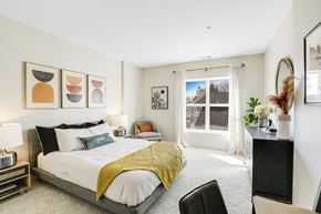 Danvers apartment for rent - A bedroom with a bed, chair, and pictures on the wall.