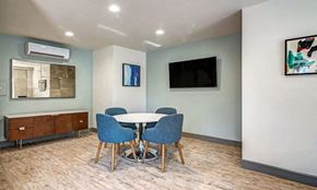 Poway apartment for rent - a dining room with a table and chairs and a television