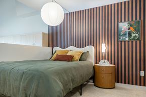 San Diego apartment for rent - A bedroom with a bed, a side table, and a painting on the wall.