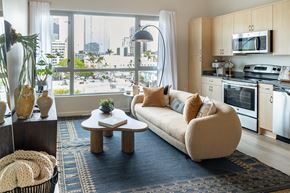 San Diego apartment for rent - A modern living room with a large window overlooking the city.