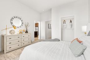 Medford apartment for rent - A bedroom with a large bed and a dresser with a mirror above it.