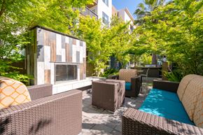 San Jose apartment for rent - a patio with wicker furniture and a pool