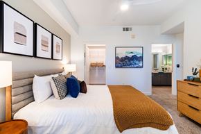 Cupertino apartment for rent - A bedroom with a large bed and a painting on the wall.