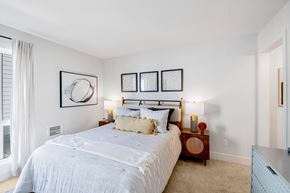 Fremont apartment for rent - A bedroom with a large bed and a window with curtains.