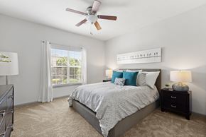 Johns Creek apartment for rent - a bedroom with a bed and a ceiling fan