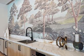 Gaithersburg apartment for rent - a kitchen with a sink and a mural on the wall