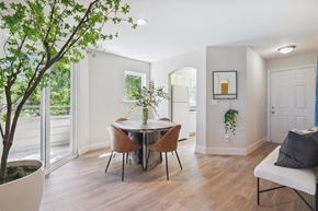 Beaverton apartment for rent - a dining room with a table and chairs and a door to a balcony