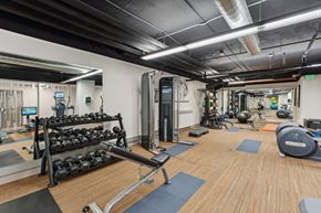 Seattle apartment for rent - a gym with weights and other exercise equipment on a wooden floor
