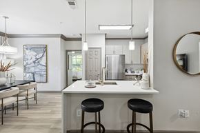 Atlanta apartment for rent - a kitchen with a white counter top and black stools