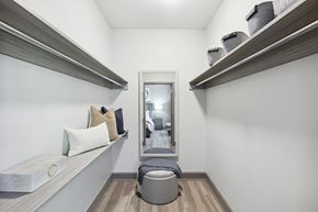 Atlanta apartment for rent - a hallway with shelves and a mirror and a seating area with pillows