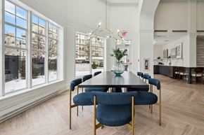 Danvers apartment for rent - a dining room with a long table and blue chairs