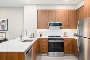 South San Francisco apartment for rent - a kitchen with wooden cabinets and stainless steel appliances