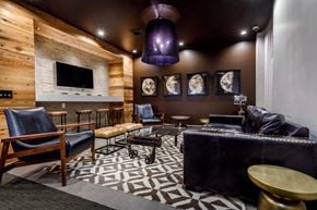Brooklyn apartment for rent - A modern living room with a wooden wall and a black couch.