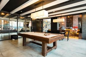 Brooklyn apartment for rent - A pool table in a room with a glass wall.