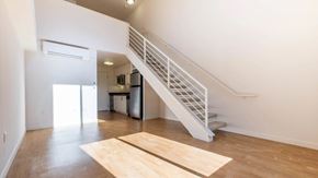 Glendale apartment for rent - A white staircase with a metal railing leads up to a second floor.