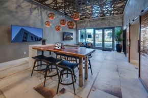 Milpitas apartment for rent - a dining room with a wooden table and bar stools